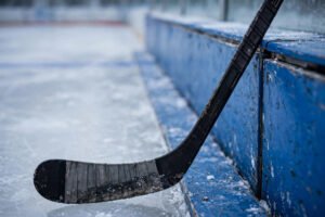 Ice hockey stick with shaft and blade on the ice